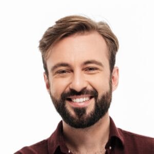Full length portrait of a smiling young man standing and showing thumbs up gesture isolated over white background
