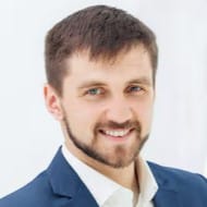 smiling-male-office-worker-against-white-office_155003-14460